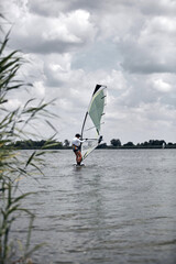 Windsurfer surfing on a windy summertime day at the river.