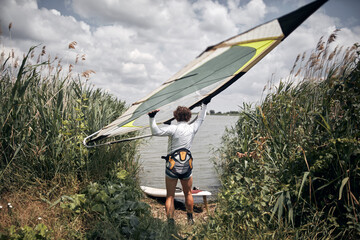Windsurfer surfing on a windy summertime day at the river.