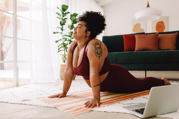 Fitness woman stretching at home