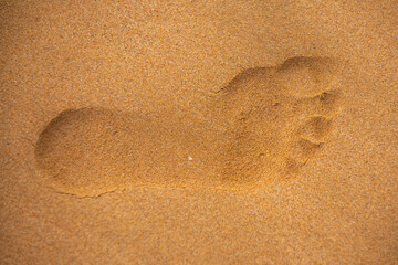 Fototapeta na wymiar Close up foot steps on beach in sandy.