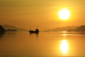 Fototapeta na wymiar Two suns and a cargo ship