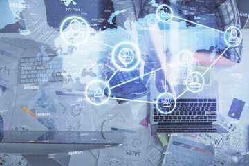 Double exposure of man and woman working together and social network theme hologram drawing. Computer background. connecting concept. Top View.
