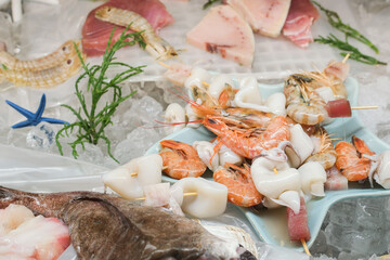 Fresh seafood and fish on the market. Tuna, perch, shrimp, squid, langoustines on ice
