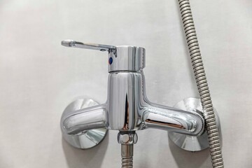 Close-up of modern aluminum shower faucet with lever