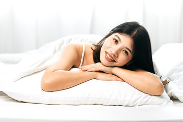 Obraz na płótnie Canvas Young women smile happy lying in bed in the morning, modern lifestyle holiday rest home, female looking fresh relaxing, mental health concept.