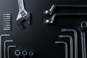 Repair tools. Metallic wrenches for home manual repair work. Set of hardware tool for construction on dark background. Frame composition with copy space top view.