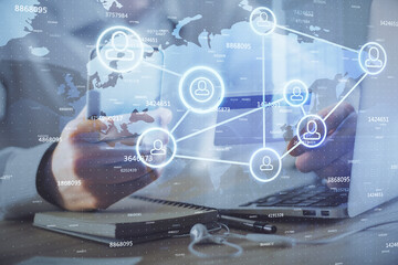 Double exposure of man hands holding a credit card and social network theme drawing. Digital finance and E-commerce concept.