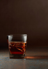 Glass of whiskey on a rusty background.