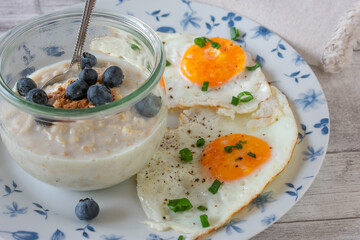 Homemade Breakfast with oats, blueberries and eggs on plate