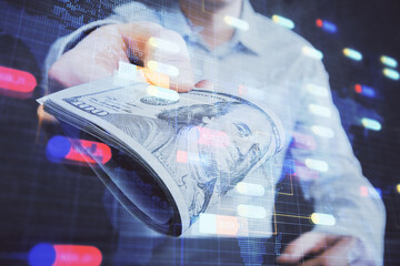 Double exposure of technology drawing hologram and us dollars bills and man hands. Data concept