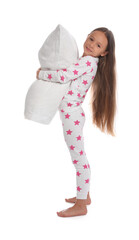 Cute girl wearing pajamas with pillow on white background