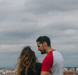 Young couple in love kissing and laughing in a park