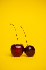 ripe cherries close-up on a yellow background
