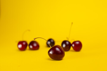 ripe cherries close-up on a yellow background