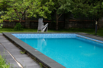 summer swimming pool in the courtyard with a garden