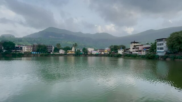 Scenic View Of Urban Landscape On Lakeshore In Trimbakeshwar City, Trimbak, Maharashtra, India. - Panning Shot