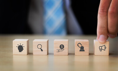 Digital marketing funnel concept: winning new customers with marketing strategies ; wooden cubes...