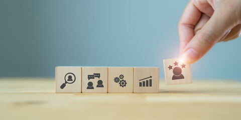 Human resource management concept. Manager hold cube with promoted staff icon and HRM stage icon on...