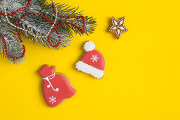 Christmas composition with gingerbread on the yellow background. Top view. Copy space.