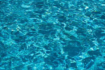 Fototapeta na wymiar Abstract ripple wave and clear turquoise water surface in swimming pool, blue water wave for background and abstract design.