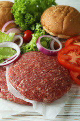Concept of cooking burger on white wooden table