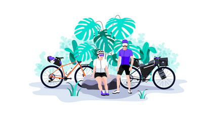 Young couple resting on nature during bike trip.