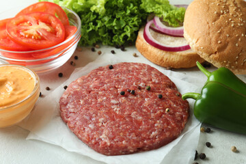 Concept of cooking burger on white textured background