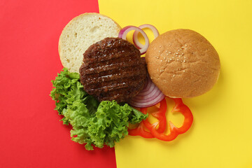 Concept of cooking burger on two tone background