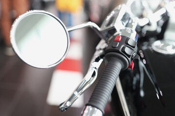 Motorcycle mirror with throttle handle on handlebars closeup