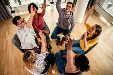 Fototapeta na wymiar Diverse group of people sitting in circle in group therapy session.
