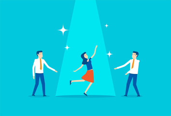 Businesswoman raises fist in a spotlight