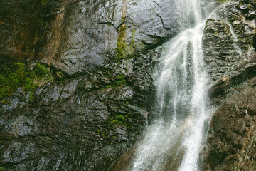 Waterfall flowing down close-up. Natural background. 