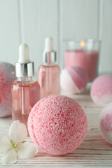 Body care concept with bath balls on white wooden table