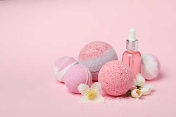 Body care concept with bath balls on pink background