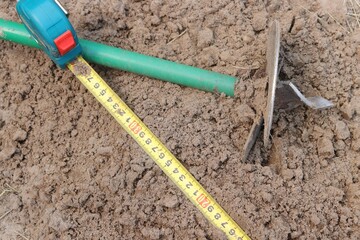 ruler on the ground, yellow tape measure measures the ground