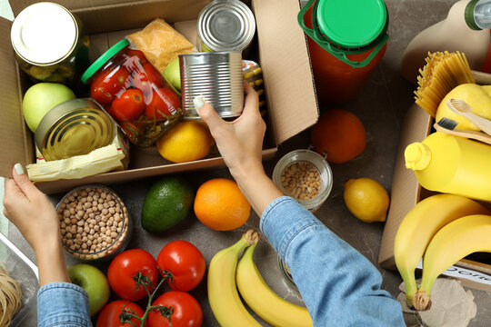 Donation concept with female hands and different food