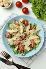 Concept of tasty eating with Caesar salad on white background