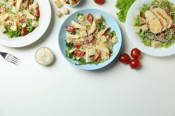 Concept of tasty eating with Caesar salad on white background