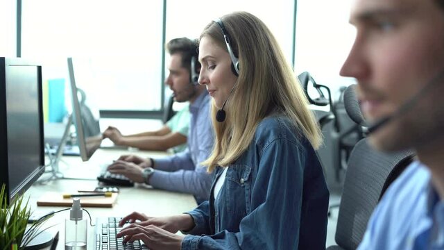 Male representative call center agent in wireless headset helping client, operator working in customer support service