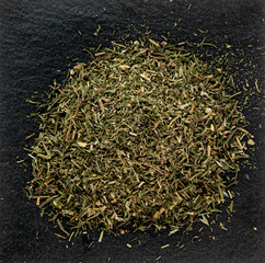 Crushed fragrant dried thyme, spice for cooking, macro photography