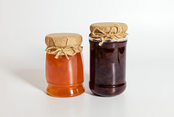 Berry and fruit jam on white background. Strawberry and apricot jam.