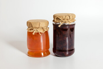 Berry and fruit jam on white background. Strawberry and apricot jam.