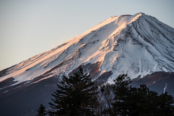 Mount Fuji at early morning sunrise. Snow covered peak of Japan's highest mountain and active volcano.