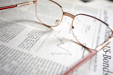 eyeglasses on the newspaper pages