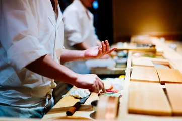 Muurstickers sushi chef hand madecooking © Teerayut