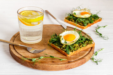 Toasts with avocado and fried eggs. Healthy breakfast