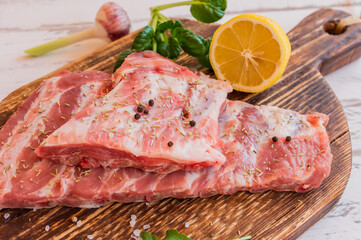Raw pork meat ribs set, on wooden table background, close up view