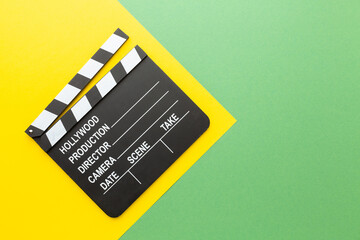 retro camera clapperboard on a colored background.