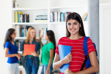 Laughing hispanic female student with group of multi ethnic college students