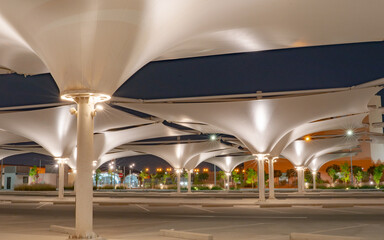 doha,qatar- May 03 2021 : Car park with umbrella to provide shade for vehicles during the summer...